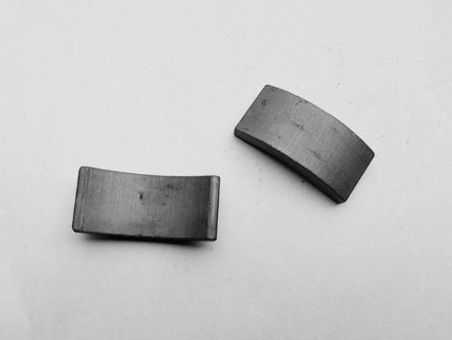 Motor arc segmented ferrite magnets